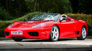 Sleek Red Ferrari 360 Modena On The Road Wallpaper