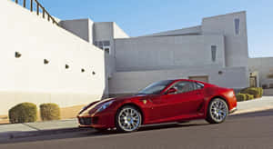 Sleek Red Ferrari 599 Gtb Fiorano On A Picturesque Coastal Road Wallpaper