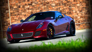 Sleek Red Ferrari 599 Gtb Fiorano On Straight Road Wallpaper