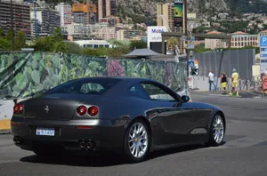 Sleek Red Ferrari 612 Scaglietti Speeding On The Open Road Wallpaper