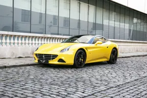 Sleek Red Ferrari California T Cruising On The Open Road Wallpaper
