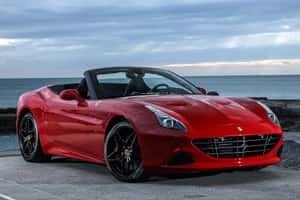 Sleek Red Ferrari California T On The Road Wallpaper