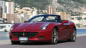 Sleek Red Ferrari California T On The Road Wallpaper