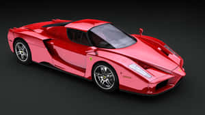 Sleek Red Ferrari Enzo In Motion Wallpaper