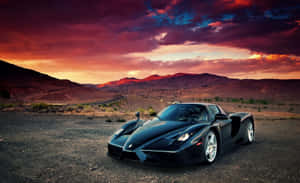 Sleek Red Ferrari Enzo On The Road Wallpaper