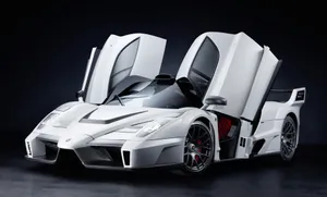 Sleek Red Ferrari Enzo Racing Through The Streets Wallpaper