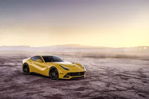 Sleek Red Ferrari F12 Berlinetta In Motion Wallpaper