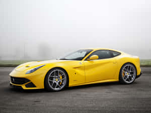 Sleek Red Ferrari Ff On Picturesque Mountain Road Wallpaper