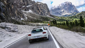 Sleek Red Ferrari Gtc4lusso On The Road Wallpaper