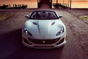 Sleek Red Ferrari Portofino On A Scenic Road Wallpaper