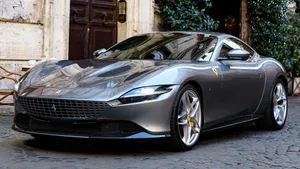 Sleek Red Ferrari Roma On The Road Wallpaper