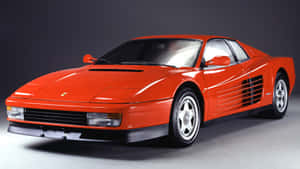 Sleek Red Ferrari Testarossa In Motion Wallpaper