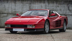 Sleek Red Ferrari Testarossa On Open Road Wallpaper