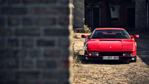 Sleek Red Ferrari Testarossa On The Road Wallpaper