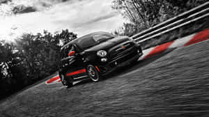 Sleek Red Fiat 500 On City Street Wallpaper