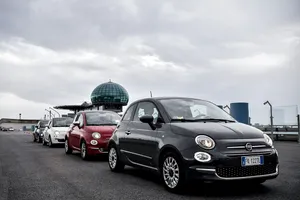 Sleek Red Fiat 500 Parked In Picturesque Venue Wallpaper