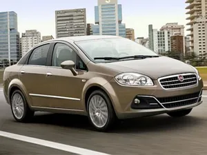 Sleek Red Fiat Punto Driving On An Open Road Wallpaper