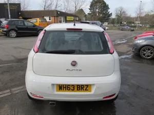 Sleek Red Fiat Punto On Open Road Wallpaper