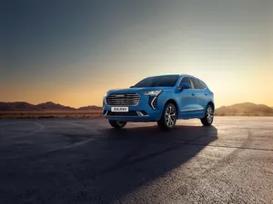 Sleek Red Haval Suv On The Open Road Wallpaper