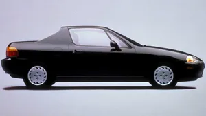 Sleek Red Honda Civic Del Sol In An Urban Setting Wallpaper