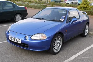 Sleek Red Honda Civic Del Sol Parked Outdoors Wallpaper