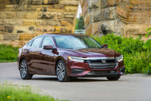 Sleek Red Honda Insight On Open Road Wallpaper