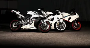 Sleek Red Honda Motorcycle In Majestic Mountain Scenery Wallpaper