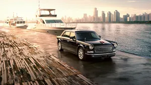 Sleek Red Hongqi Luxury Car On Road Wallpaper