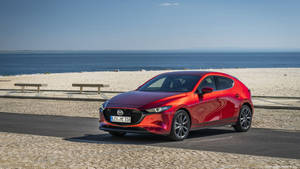 Sleek Red Mazda 3 Hatchback In High Definition Wallpaper