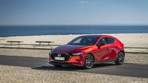 Sleek Red Mazda 3 Hatchback In High Definition Wallpaper