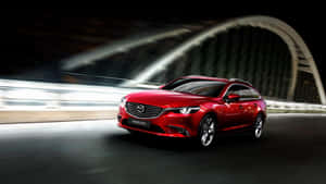 Sleek Red Mazda 6 Sports Sedan In Action Wallpaper