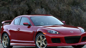 Sleek Red Mazda Rx-8 Sportscar In Scenic Driveway Wallpaper