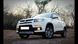 Sleek Red Sports Car In Motion On A Picturesque Road Wallpaper