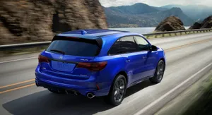 Sleek Silver Acura Mdx Cruising On The Open Road Wallpaper