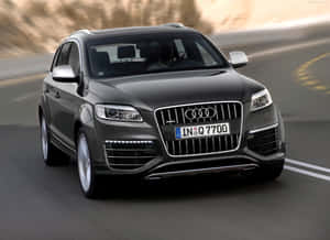 Sleek Silver Audi Q7 On A Scenic Road Wallpaper