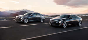 Sleek Silver Cadillac Ats On The Road Wallpaper