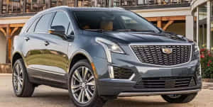 Sleek Silver Cadillac Xt5 Cruising On The Highway Wallpaper