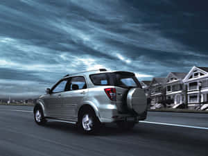 Sleek Silver Daihatsu On The Road Wallpaper
