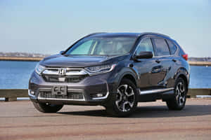 Sleek Silver Honda Cr-v On An Open Road Wallpaper