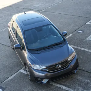 Sleek Silver Honda Fit On The Road Wallpaper