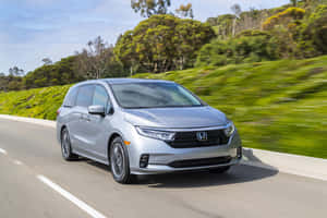 Sleek Silver Honda Odyssey Minivan On The Road Wallpaper