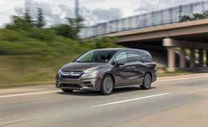 Sleek Silver Honda Odyssey On The Road Wallpaper