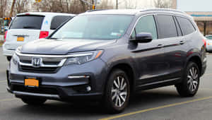 Sleek Silver Honda Pilot 2022 Parked At Scenic Location Wallpaper