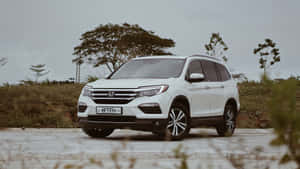 Sleek Silver Honda Pilot Suv On A City Street Wallpaper