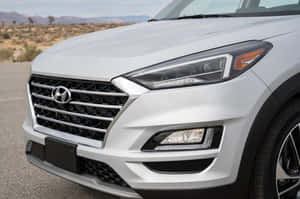 Sleek Silver Hyundai Tucson Parked By Waterfront Wallpaper