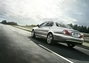 Sleek Silver Jaguar X-type On The Road Wallpaper
