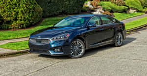 Sleek Silver Kia Cadenza Cruising On An Open Road Wallpaper