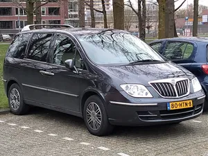 Sleek Silver Lancia Phedra On Scenic Route. Wallpaper