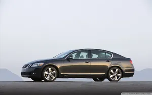 Sleek Silver Lexus Gs Cruising Through Urban Landscape Wallpaper