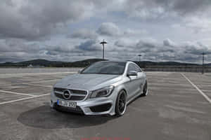Sleek Silver Mercedes Benz Cla-class Parked On The City Street. Wallpaper
